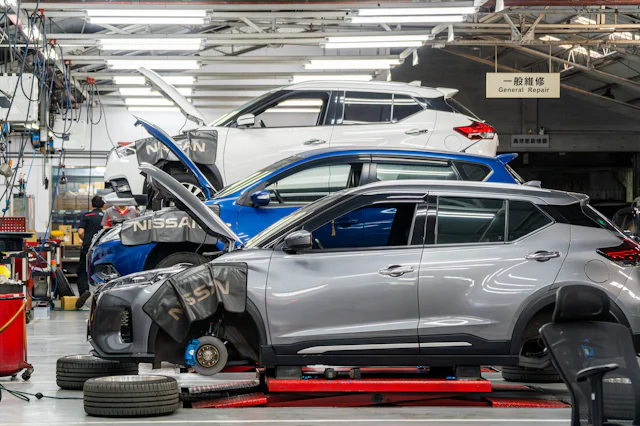 Vehicles up on lifts in a working service bay
