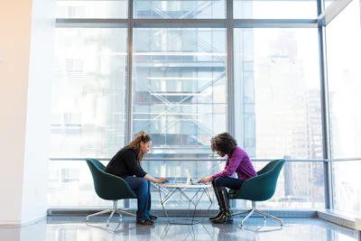 A one-to-one coaching session in a bright meeting room