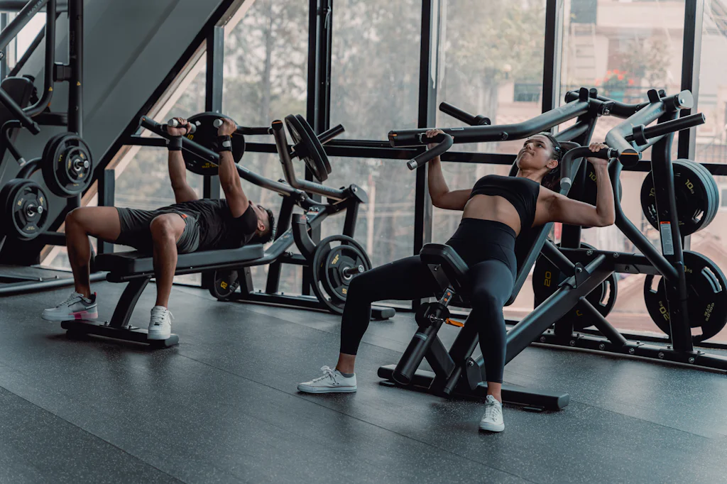 Members training on a daylit gym floor