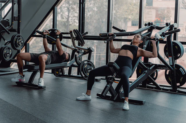 Members training on a daylit gym floor